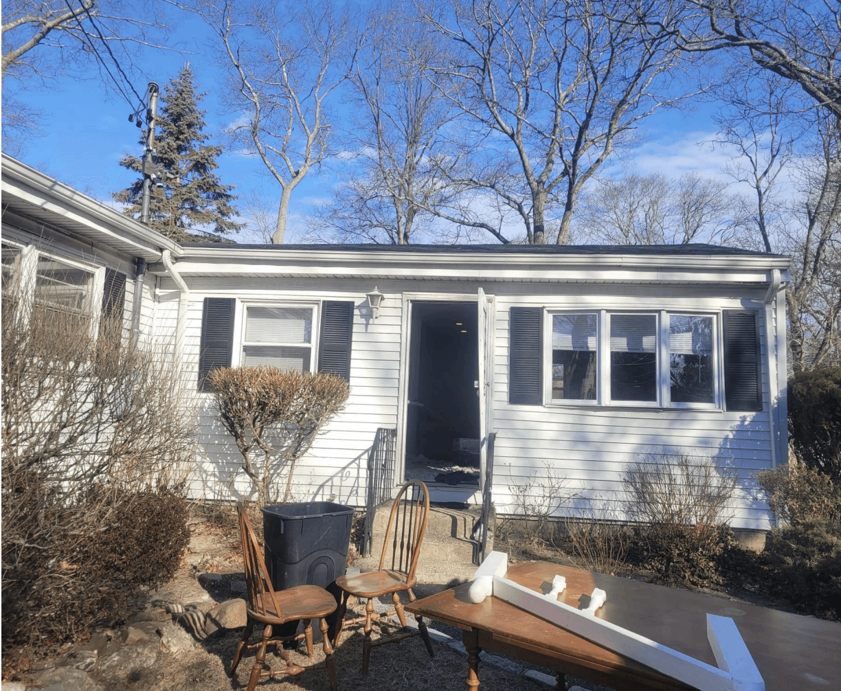 Front exterior of home before improvements in Centereach, New York