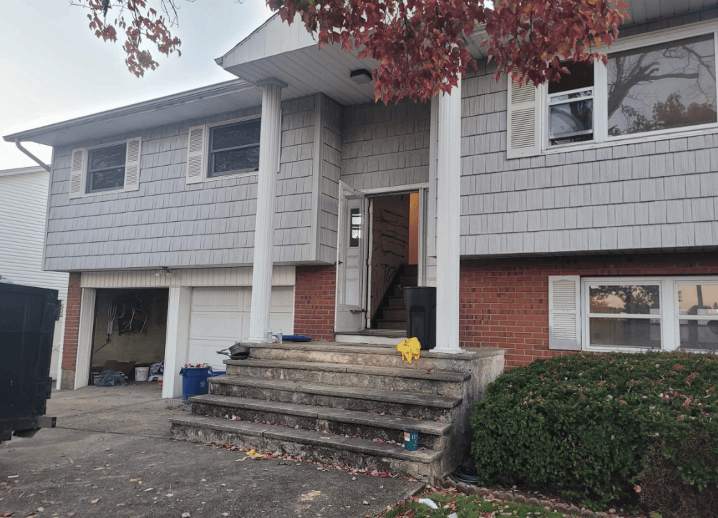 Front exterior of home before improvements in West Babylon, New York